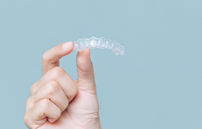Patient holding clear aligner