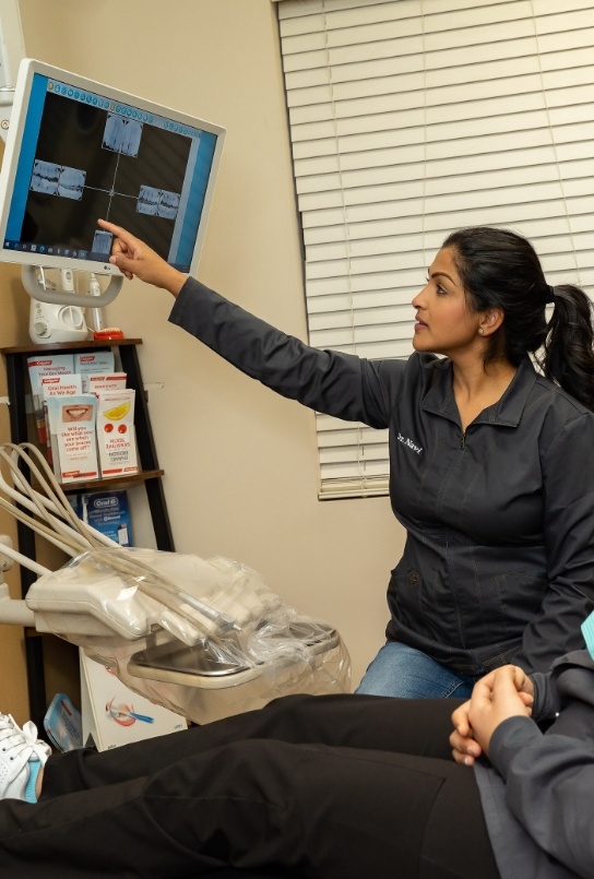 Covington dentist showing a dental patient x rays of their teeth