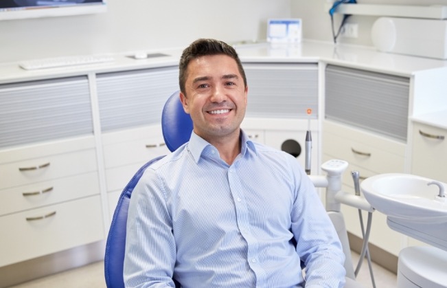 Smiling man sitting in dental chair