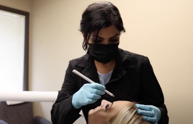 Cosmetic dentist giving a patient a Botox injection