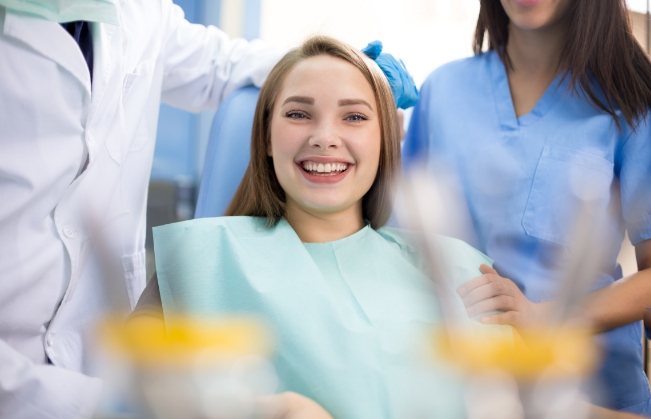 Young woman grinning in dental chair