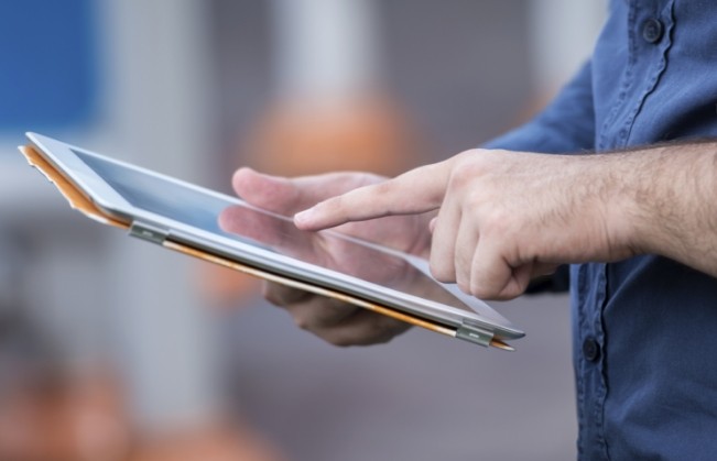 Person typing on tablet