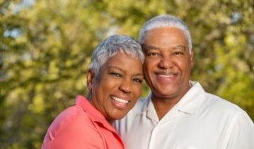 Older man and woman smiling together outdoors