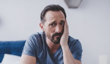 Man holding the side of his jaw in pain