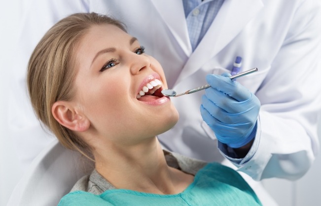 Dental patient opening her mouth for a dental checkup