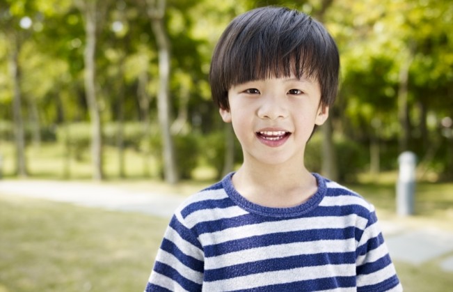 Young boy in striped shirt outdoors