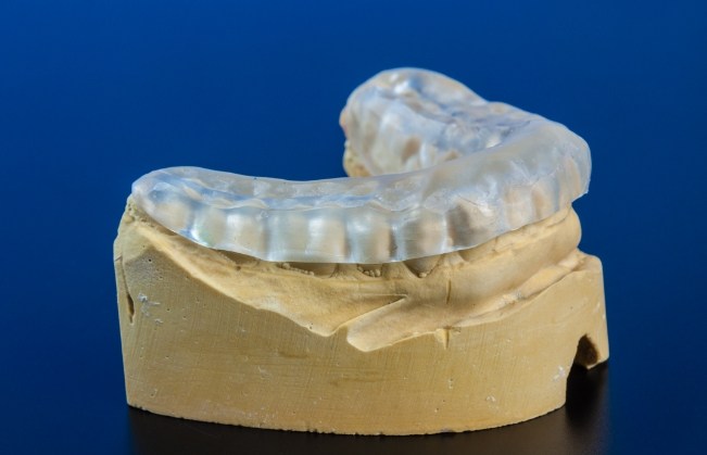 Clear nightguard on a model of the lower jaw
