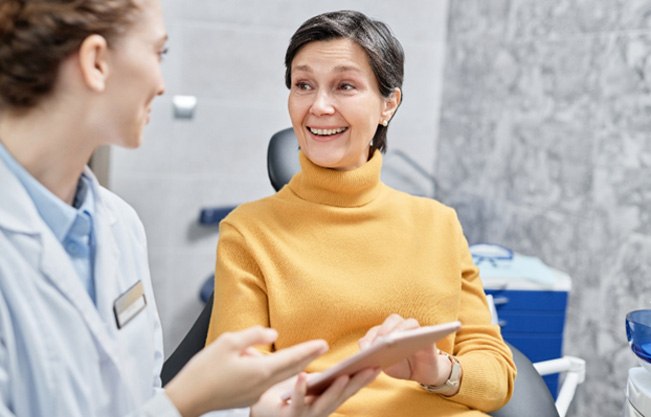 Dental implant consultation between female patient and dentist 