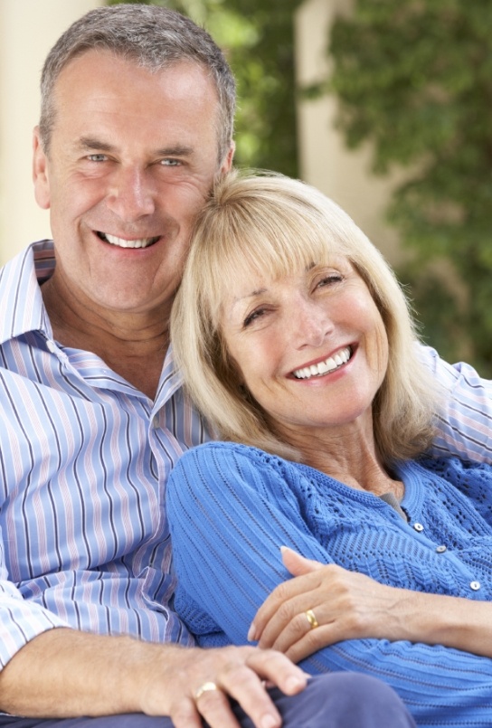 Man and woman smiling together after restorative dentistry in Covington