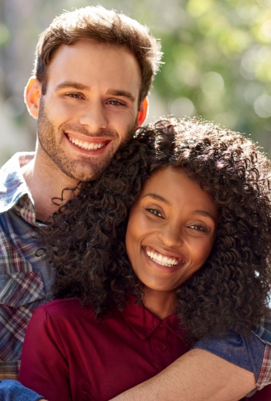 Man and woman smiling outdoors