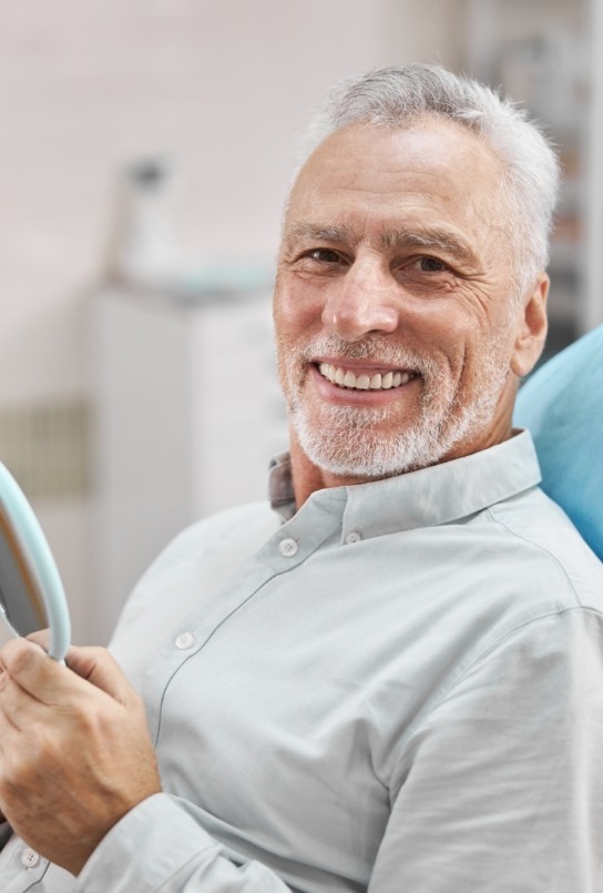 Senior man smiling because of dental special offers in Covington