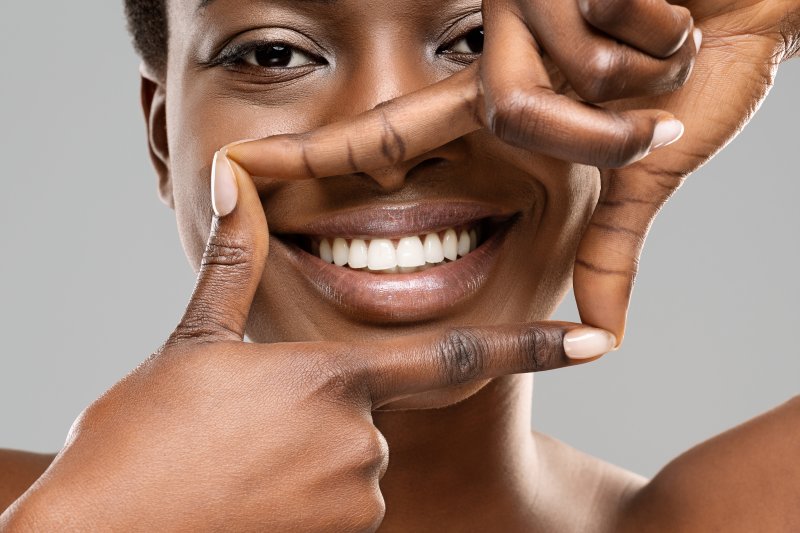 A woman smiling with her new dental veneers